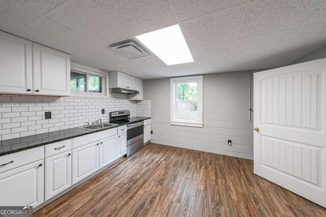 9805 Buice Rd, Alpharetta, GA 30022 - kitchen with electric range, dark countertops, dark wood-type flooring, white cabinets, and a paneled ceiling