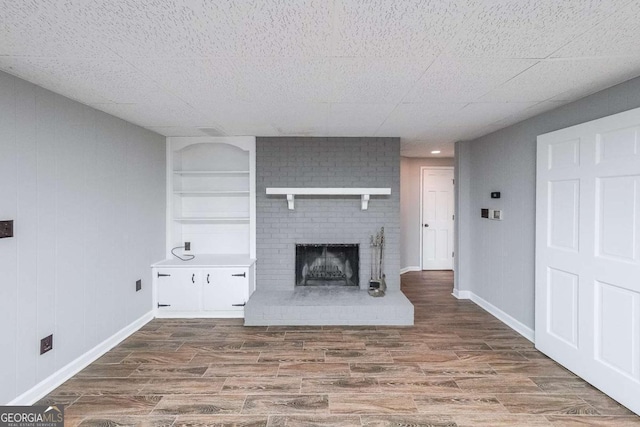 9805 Buice Rd, Alpharetta, GA 30022 - unfurnished living room with wood finished floors and a brick fireplace