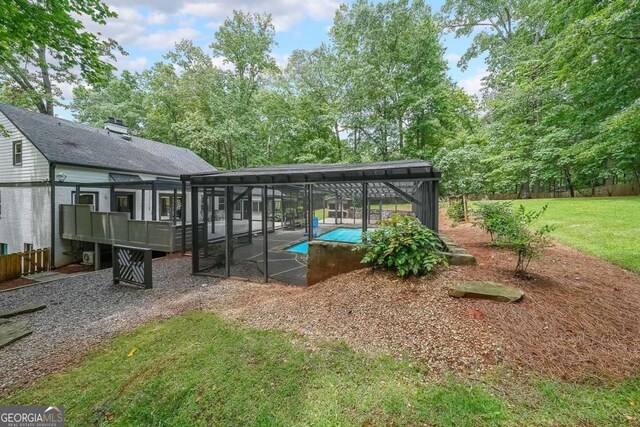 9805 Buice Rd, Alpharetta, GA 30022 - view of green lawn featuring an outdoor pool, glass enclosure, and a patio