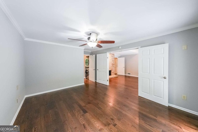 9805 Buice Rd, Alpharetta, GA 30022 - unfurnished bedroom featuring stacked washer / dryer, dark wood-style floors, crown molding, and a ceiling fan