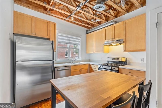 322 Peters Unit 2, Atlanta, GA 30313 - kitchen with stainless steel appliances, under cabinet range hood, wooden counters, and light brown cabinetry