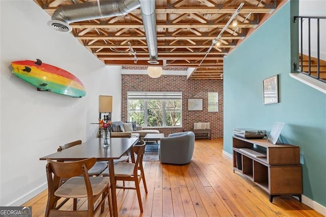 322 Peters Unit 2, Atlanta, GA 30313 - dining space featuring brick wall, hardwood / wood-style flooring, and beam ceiling