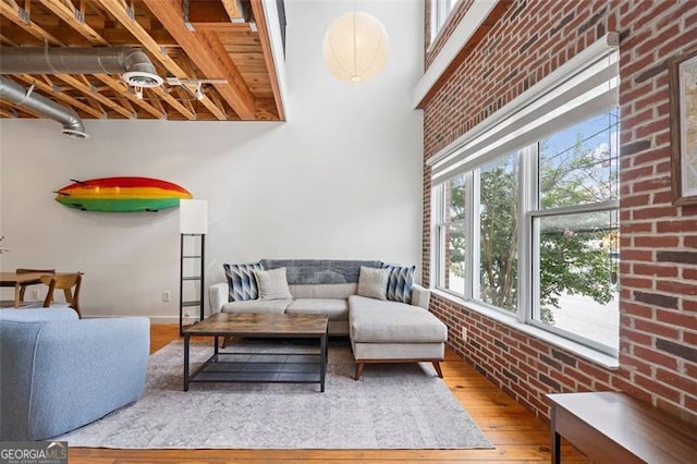 322 Peters Unit 2, Atlanta, GA 30313 - living room featuring wood finished floors and brick wall
