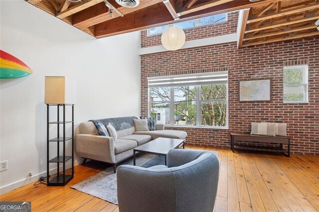 322 Peters Unit 2, Atlanta, GA 30313 - living area with brick wall, a high ceiling, wood-type flooring, and beamed ceiling