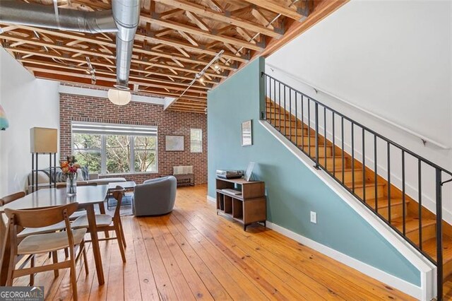 322 Peters Unit 2, Atlanta, GA 30313 - living area with brick wall, a high ceiling, wood-type flooring, and beamed ceiling