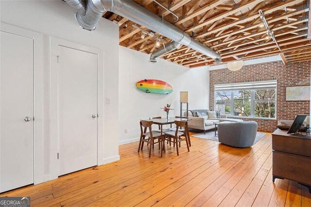 322 Peters Unit 2, Atlanta, GA 30313 - dining space featuring brick wall and light wood-style flooring
