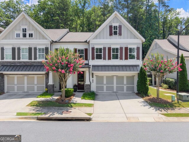 109 Bellehaven Dr, Woodstock, GA 30188 - craftsman house featuring a garage, a standing seam roof, concrete driveway, and board and batten siding