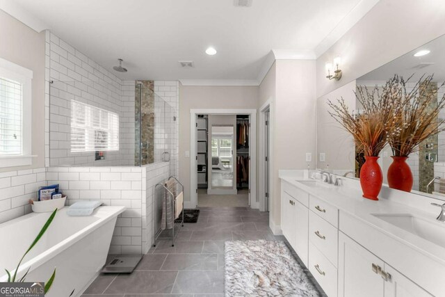 109 Bellehaven Dr, Woodstock, GA 30188 - bathroom featuring a shower stall, double vanity, a freestanding bath, healthy amount of natural light, and crown molding
