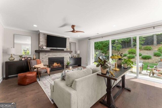 109 Bellehaven Dr, Woodstock, GA 30188 - living room featuring a large fireplace, wood finished floors, ornamental molding, recessed lighting, and a ceiling fan