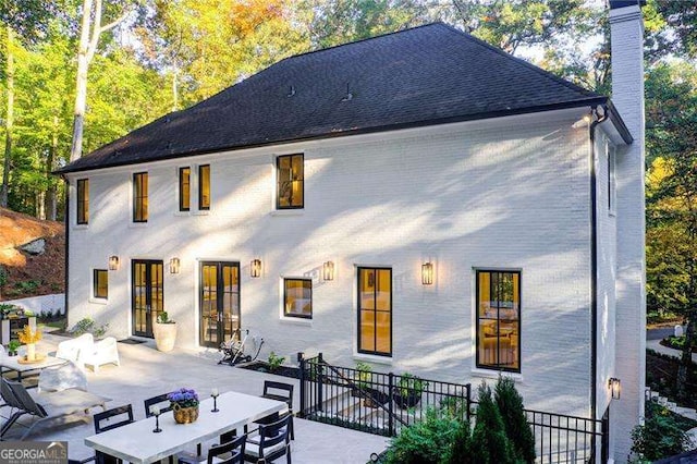 6090 River Chase Cir, Atlanta, GA 30328 - rear view of property with french doors, a patio area, a chimney, outdoor dining space, and brick siding