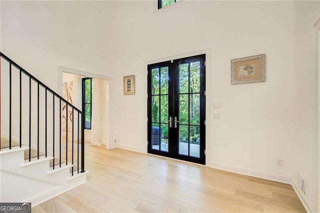 6090 River Chase Cir, Atlanta, GA 30328 - foyer entrance with french doors, stairs, and wood finished floors