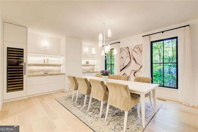 6090 River Chase Cir, Atlanta, GA 30328 - dining area with beverage cooler and light wood finished floors
