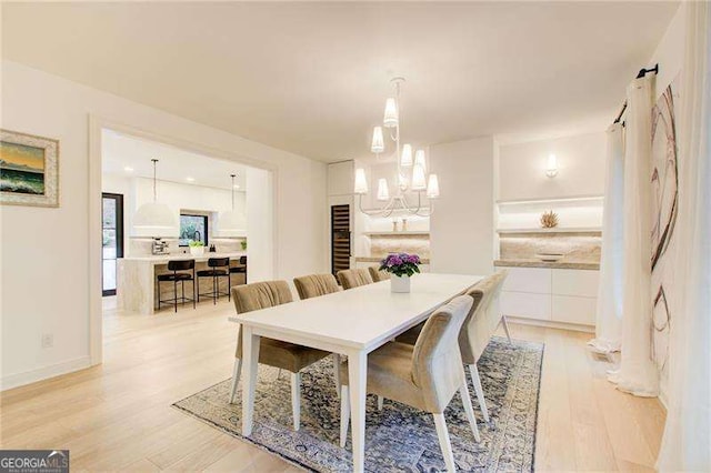 6090 River Chase Cir, Atlanta, GA 30328 - dining area featuring light wood-style flooring and a chandelier