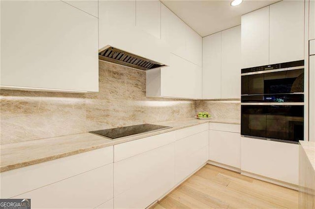 6090 River Chase Cir, Atlanta, GA 30328 - kitchen featuring black appliances, white cabinets, light wood-style floors, modern cabinets, and backsplash