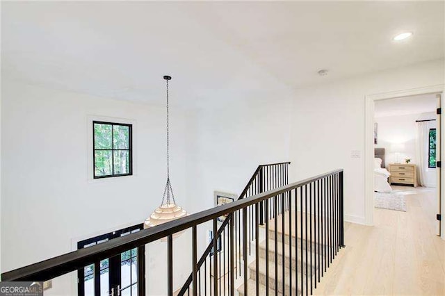 6090 River Chase Cir, Atlanta, GA 30328 - hallway with an upstairs landing, light wood-style floors, recessed lighting, and a chandelier