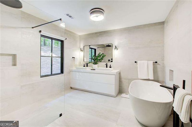 6090 River Chase Cir, Atlanta, GA 30328 - full bath with tile walls, tiled shower, double vanity, a freestanding tub, and tile patterned flooring