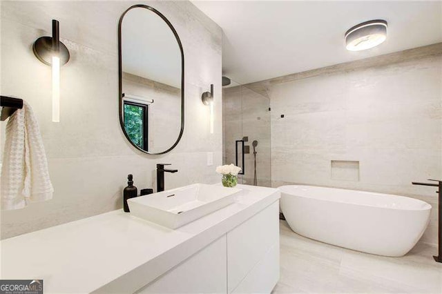 6090 River Chase Cir, Atlanta, GA 30328 - bathroom featuring a freestanding tub, vanity, tile walls, and a stall shower