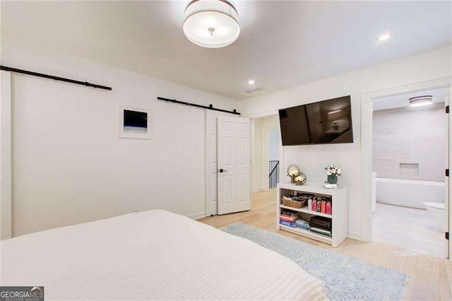 6090 River Chase Cir, Atlanta, GA 30328 - bedroom with a barn door, light wood finished floors, and recessed lighting