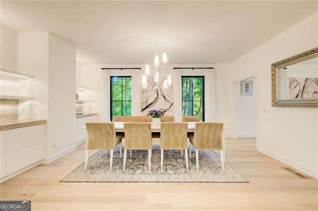 6090 River Chase Cir, Atlanta, GA 30328 - dining area with light wood finished floors, healthy amount of natural light, and a chandelier