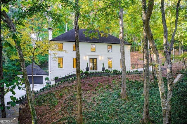 6090 River Chase Cir, Atlanta, GA 30328 - view of front of house with a chimney and a detached garage