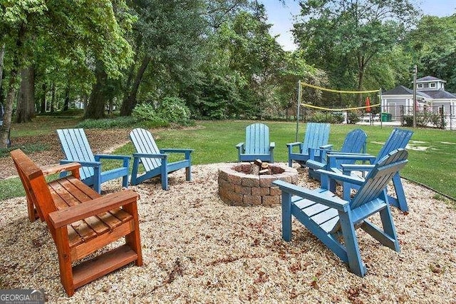 6090 River Chase Cir, Atlanta, GA 30328 - view of grassy yard featuring an outdoor fire pit, volleyball court, and view of wooded area