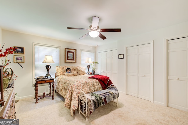 2440 Weatherford Ct, Marietta, GA 30068 - bedroom with light carpet, two closets, and ceiling fan