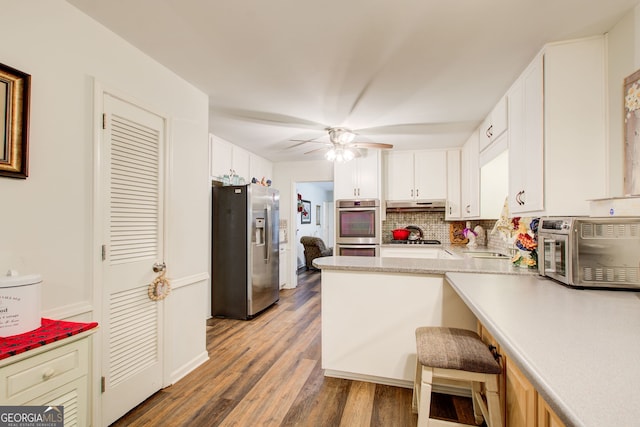 2440 Weatherford Ct, Marietta, GA 30068 - kitchen featuring stainless steel appliances, white cabinetry, light countertops, and a ceiling fan