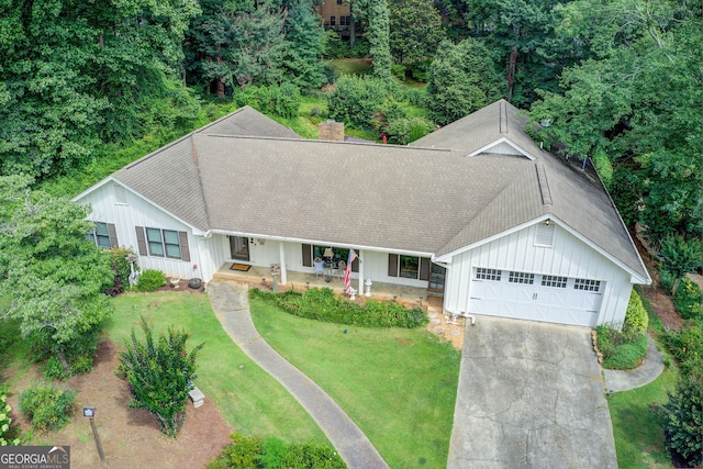 2440 Weatherford Ct, Marietta, GA 30068 - view of front of house featuring board and batten siding, roof with shingles, concrete driveway, and a front yard