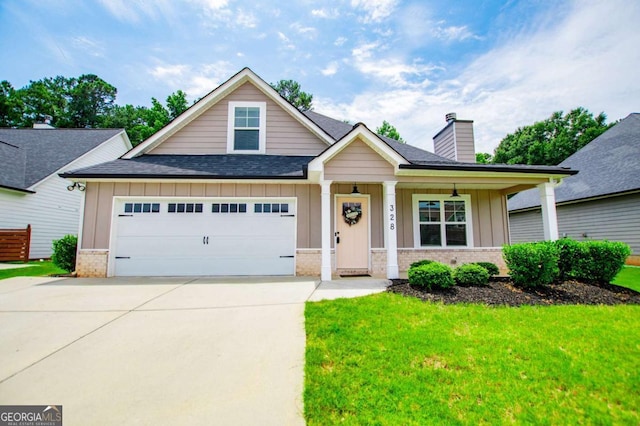 328 Brookstone Dr, Carrollton, GA 30116 - view of front of property with brick siding, board and batten siding, roof with shingles, an attached garage, and a front yard