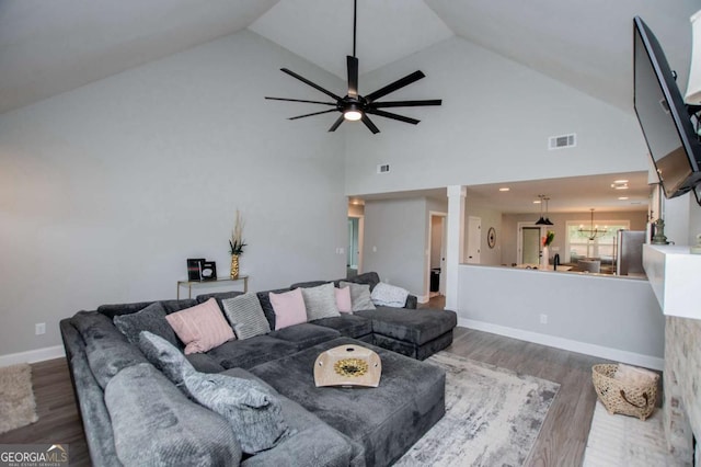 328 Brookstone Dr, Carrollton, GA 30116 - living room with ornate columns, dark wood-style floors, a ceiling fan, and high vaulted ceiling