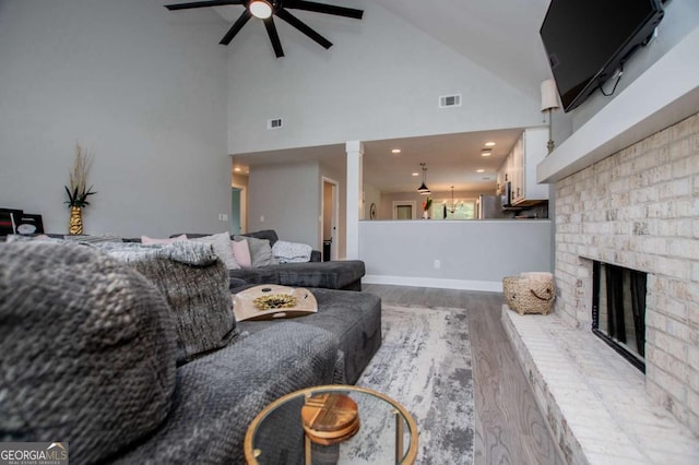 328 Brookstone Dr, Carrollton, GA 30116 - living room featuring ceiling fan, wood finished floors, a fireplace, and high vaulted ceiling
