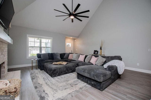 328 Brookstone Dr, Carrollton, GA 30116 - living area featuring a fireplace, a ceiling fan, high vaulted ceiling, and wood finished floors