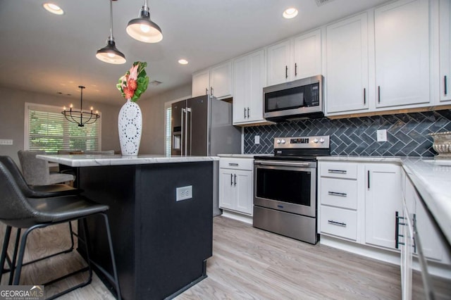 328 Brookstone Dr, Carrollton, GA 30116 - kitchen with stainless steel appliances, white cabinetry, decorative backsplash, light countertops, and recessed lighting