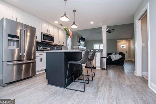 328 Brookstone Dr, Carrollton, GA 30116 - kitchen featuring stainless steel appliances, white cabinetry, light wood-type flooring, backsplash, and recessed lighting