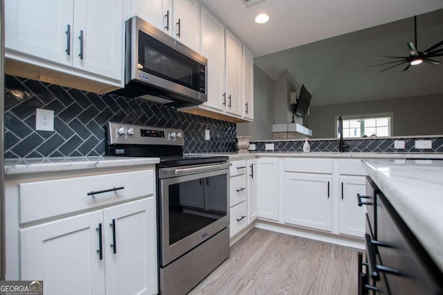 328 Brookstone Dr, Carrollton, GA 30116 - kitchen featuring stainless steel appliances, light wood-style flooring, white cabinets, recessed lighting, and tasteful backsplash