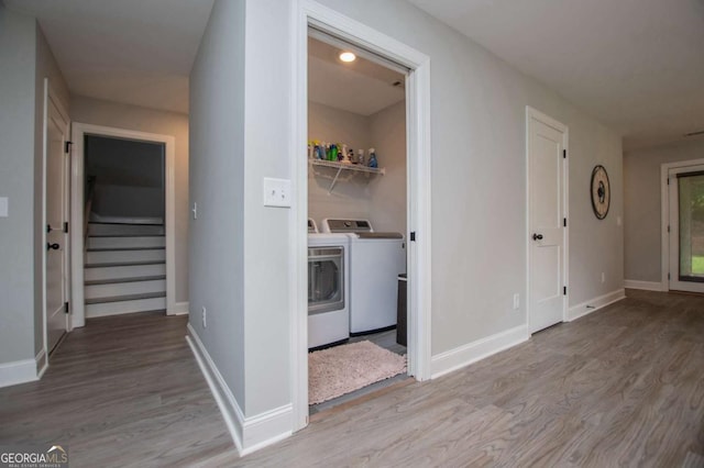 328 Brookstone Dr, Carrollton, GA 30116 - hallway featuring separate washer and dryer, wood finished floors, and stairs