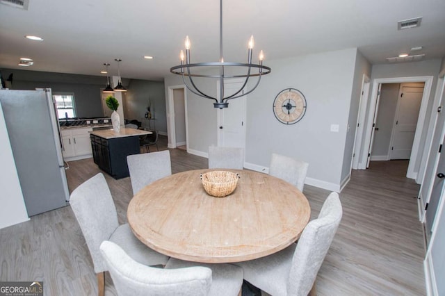 328 Brookstone Dr, Carrollton, GA 30116 - dining room featuring a chandelier, light wood-type flooring, and recessed lighting