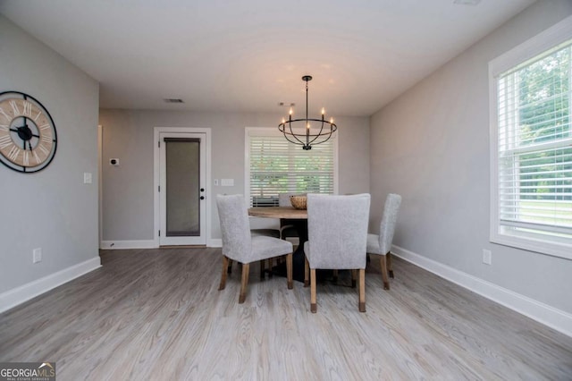 328 Brookstone Dr, Carrollton, GA 30116 - dining area with healthy amount of natural light, a chandelier, and wood finished floors