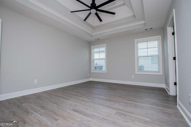 328 Brookstone Dr, Carrollton, GA 30116 - empty room with a tray ceiling, ceiling fan, wood finished floors, and ornamental molding