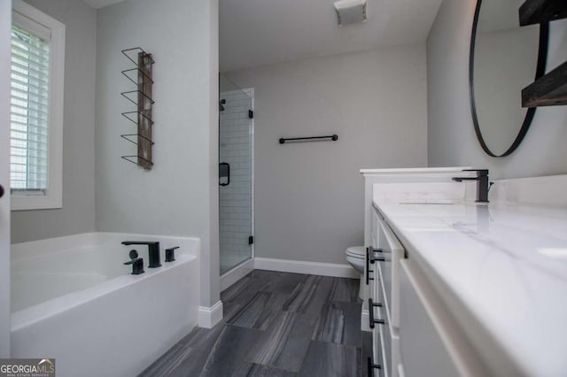 328 Brookstone Dr, Carrollton, GA 30116 - bathroom featuring vanity, a garden tub, a shower stall, and wood finished floors
