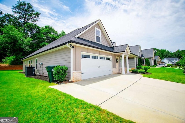 328 Brookstone Dr, Carrollton, GA 30116 - view of home's exterior featuring driveway, board and batten siding, a yard, brick siding, and a shingled roof