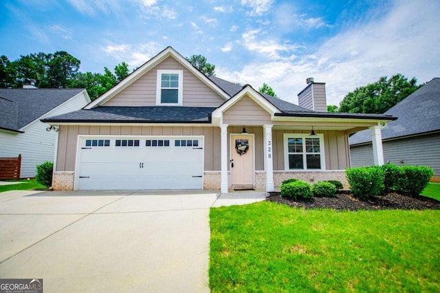 328 Brookstone Dr, Carrollton, GA 30116 - view of front of house featuring brick siding, board and batten siding, roof with shingles, a garage, and a front yard