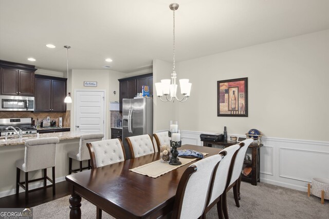 115 Court Xing, Locust Grove, GA 30248 - dining space featuring a chandelier, wainscoting, recessed lighting, and light colored carpet