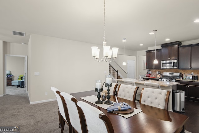 115 Court Xing, Locust Grove, GA 30248 - dining area featuring a chandelier, recessed lighting, and dark colored carpet