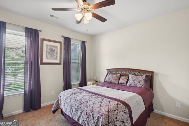 115 Court Xing, Locust Grove, GA 30248 - bedroom with carpet flooring, multiple windows, and a ceiling fan