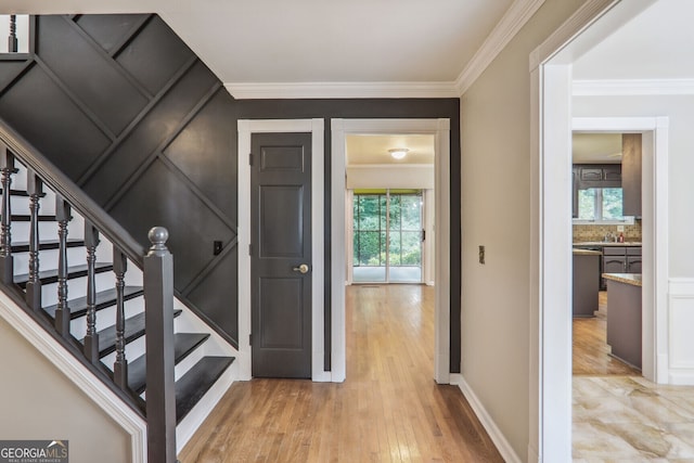 9055 Green Valley Ct, Douglasville, GA 30134 - stairway with healthy amount of natural light, crown molding, and wood finished floors
