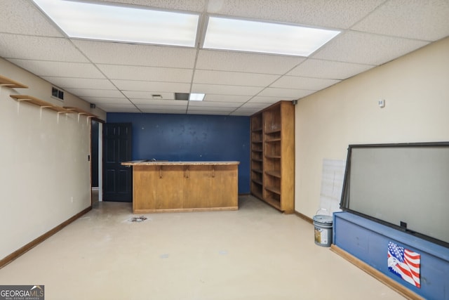 9055 Green Valley Ct, Douglasville, GA 30134 - indoor dry bar featuring a paneled ceiling and concrete flooring