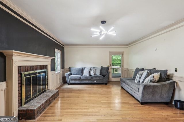9055 Green Valley Ct, Douglasville, GA 30134 - living room with crown molding, light wood-style flooring, wainscoting, a fireplace, and a decorative wall