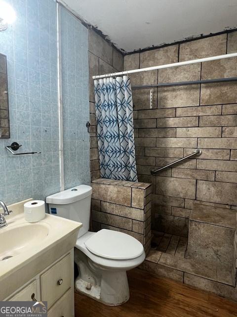 1041 Sandy Ridge Rd, Mcdonough, GA 30252 - full bathroom with wood finished floors, a tile shower, and vanity