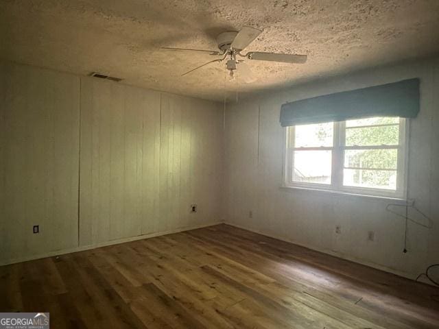1041 Sandy Ridge Rd, Mcdonough, GA 30252 - empty room with wood finished floors, a textured ceiling, and ceiling fan